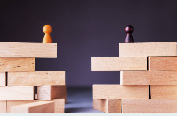 Wooden blocks with pawns, symbolising a communication gap.