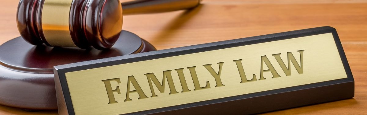 Family law signage next to a judge's gavel on a wooden desk.