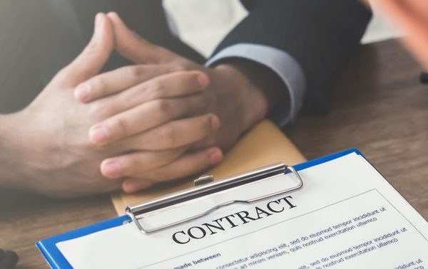 Business meeting with a contract on the table.