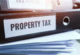 Property tax folders stacked with papers, highlighting tax documentation.