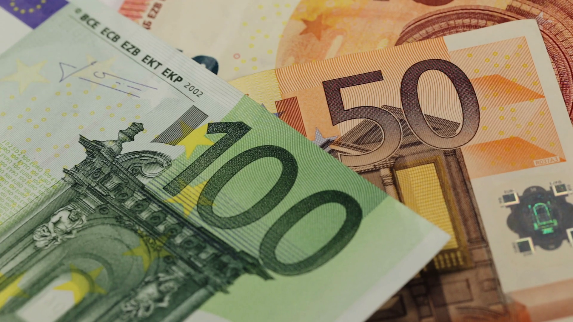 Euro banknotes in denominations of 100 and 50, close-up view.