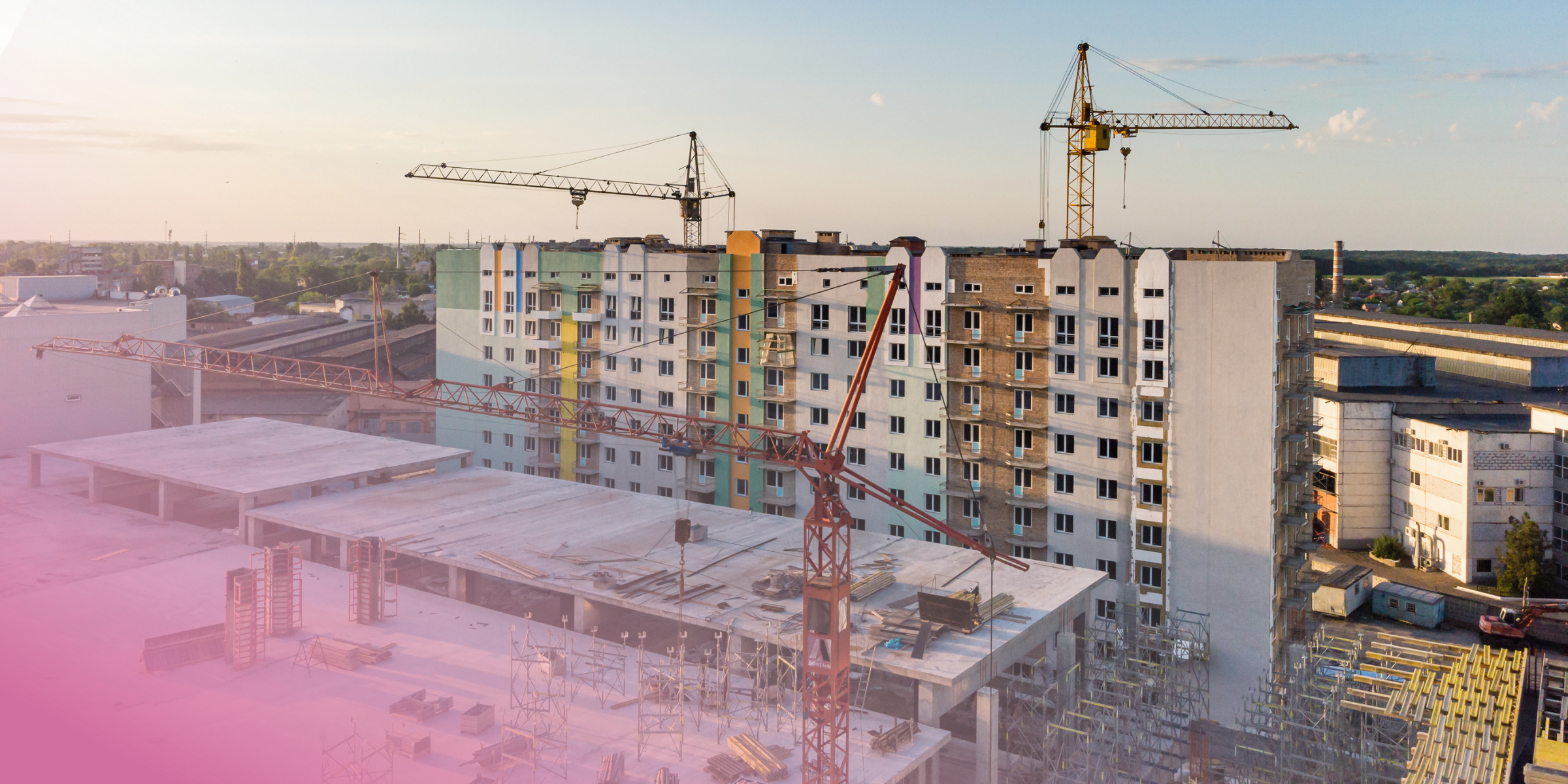 Urban construction site with cranes and high-rise buildings under development.