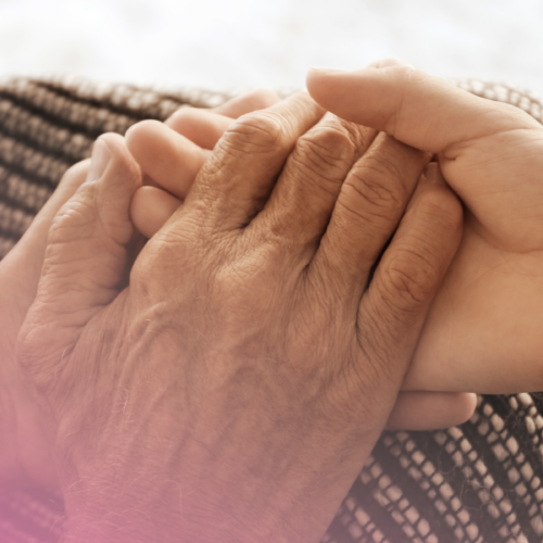 Holding an elderly lady's hands to symbol caring for their capacity