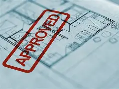 Blueprint of a building with an approved stamp in red.