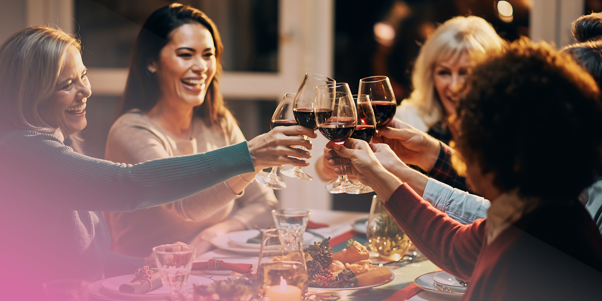 Friends toasting wine glasses at dinner party celebration