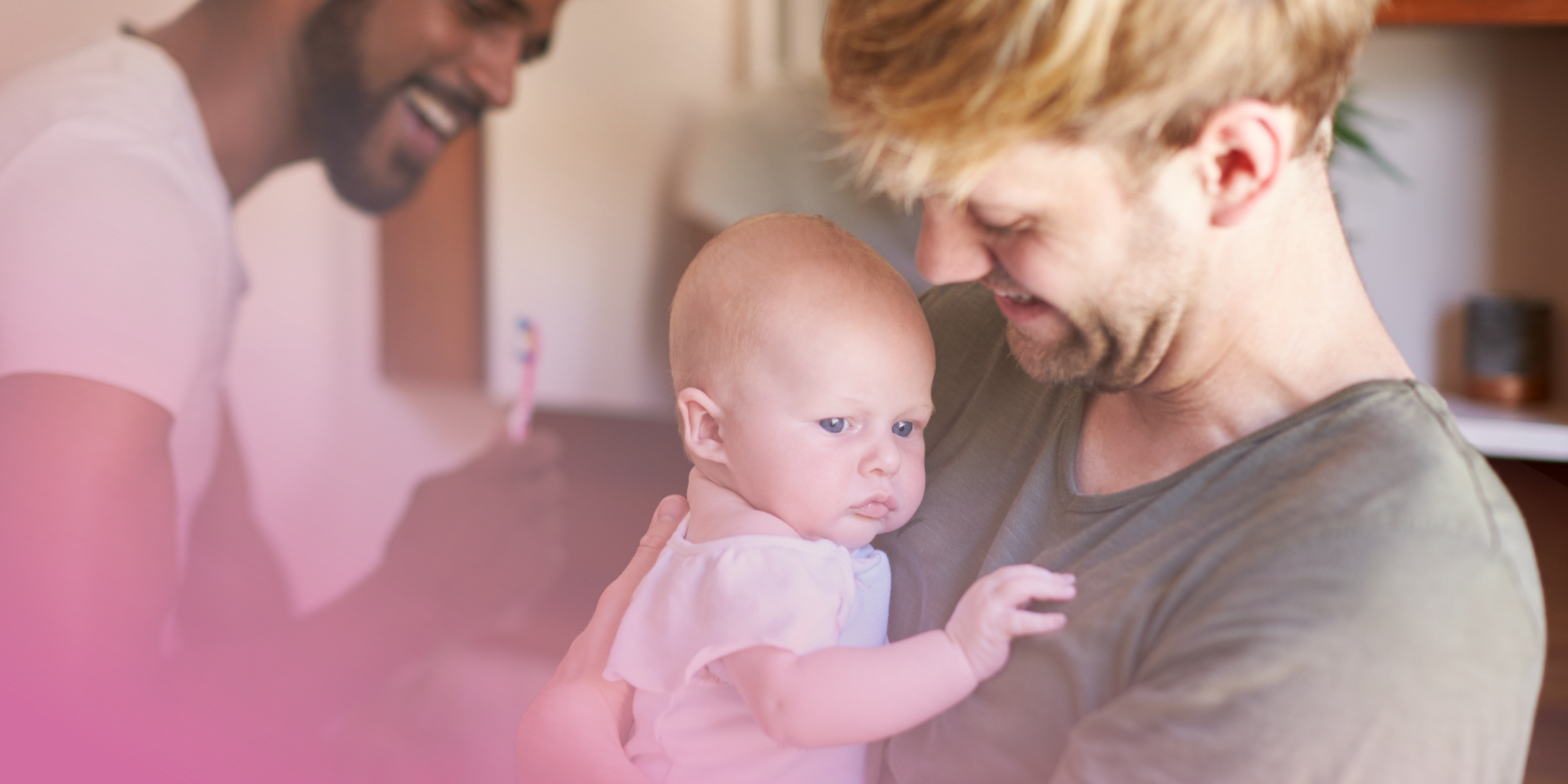 A happy family moment: smiling parents with their baby at home.